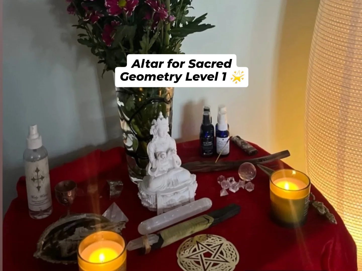 Sacred altar setup for Sacred Geometry Level 1 with candles, crystals, and flowers